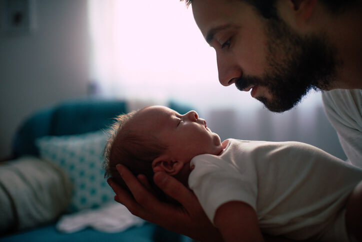 Man holding baby in his hand