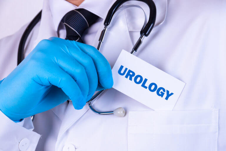 Doctor holding a card with text UROLOGY