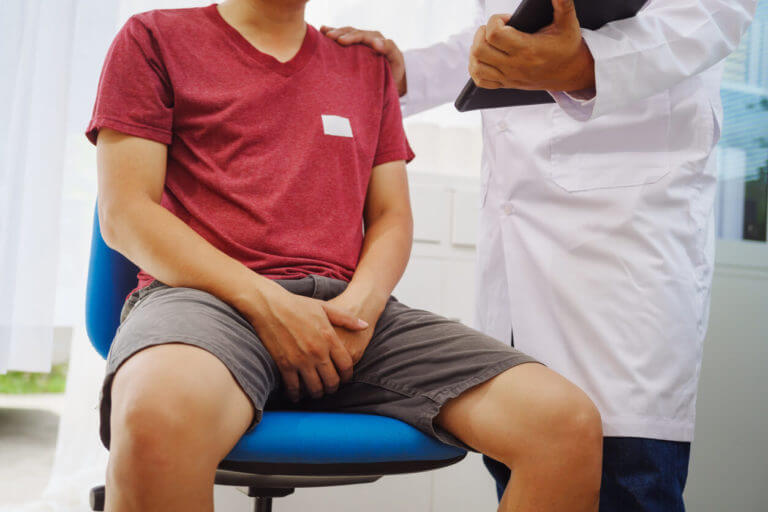 A man with enlargement of the prostate gland, consults a doctor in a hospital.