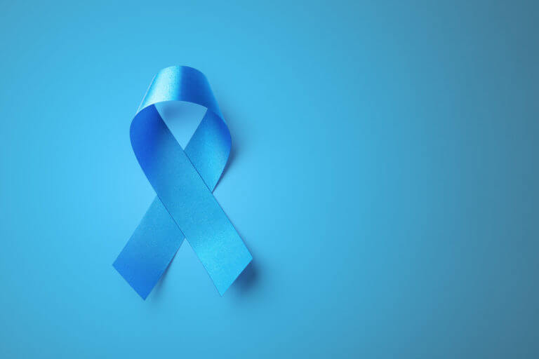 Blue ribbon on blue background used for health awareness of prostate cancer.